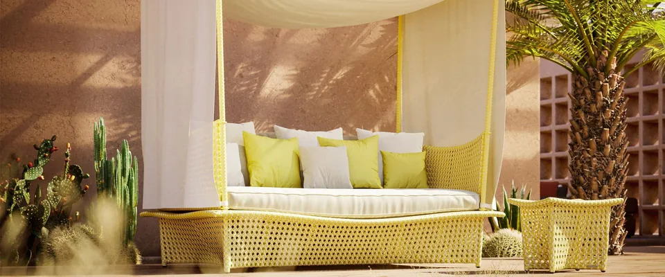 Dedon Daydream daybed in citrine Dedon Fiber, canopy patio furniture by a pool