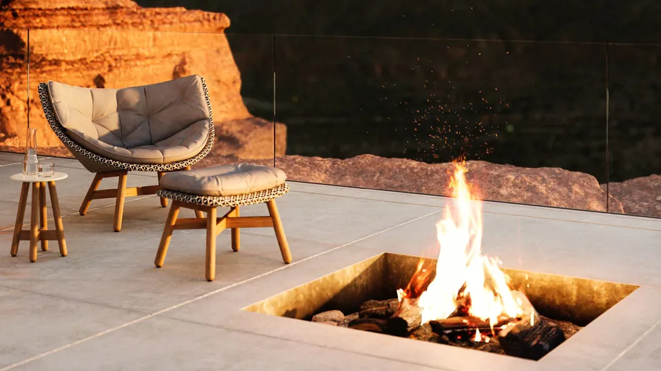 Luxury furniture by Dedon, Mbrace chairs in Dedon Fiber on a mountain terrace
