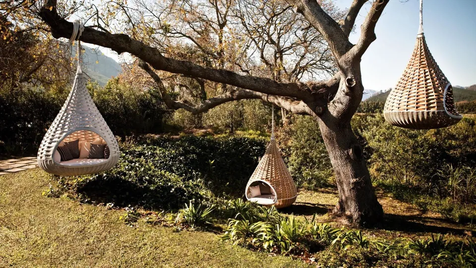 Dedon furniture outdoors, Nestrest hanging lounger woven by hand from Dedon Fiber