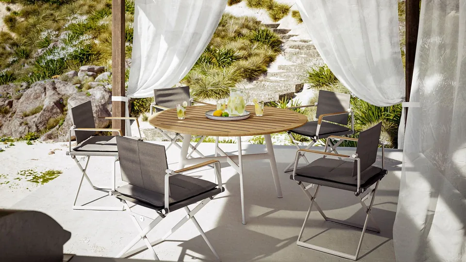 Dedon Seax folding armchair and dining table, an outdoor dining set with a Black Pepper frame