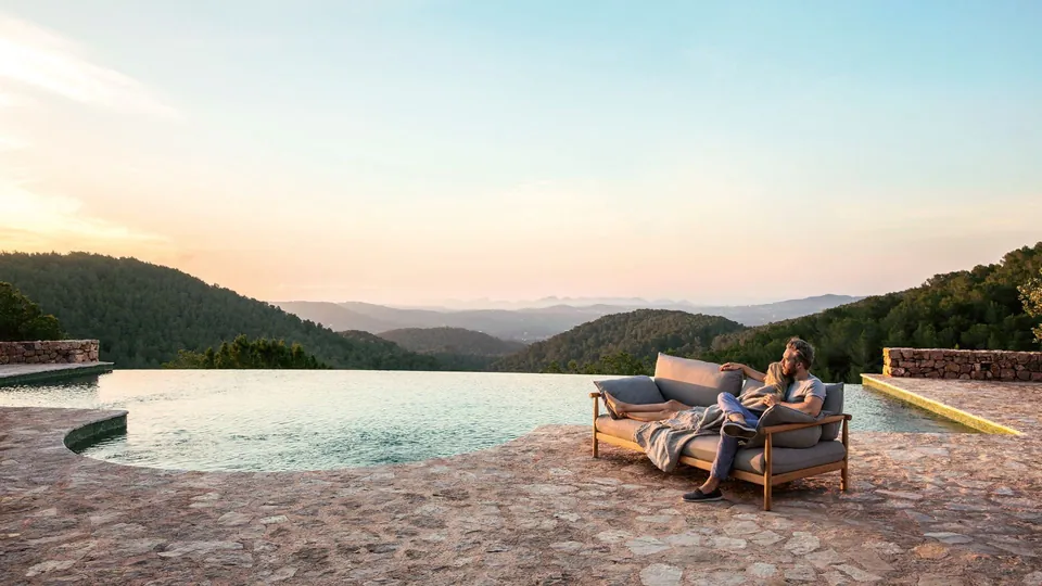 Dedon outdoor furniture on the patio, Tibbo teak and woven fiber pieces by the pool